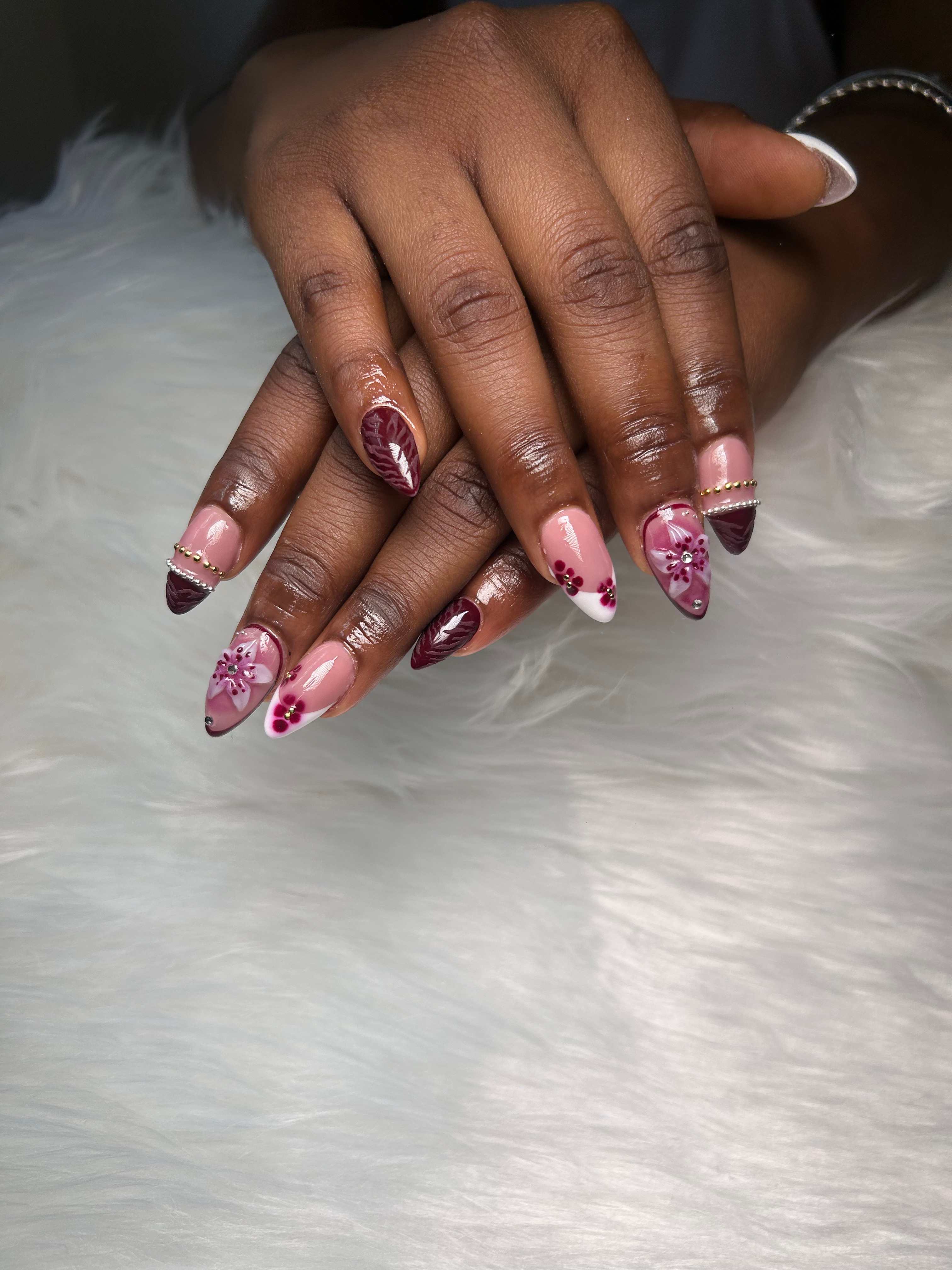 Milky nude nails with hand-painted flowers and gems